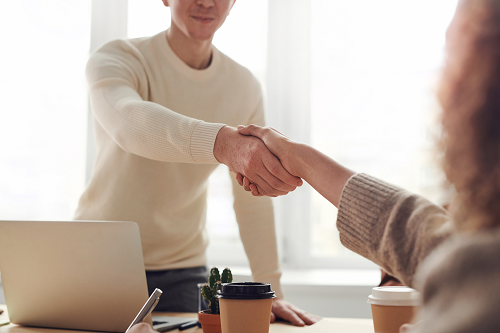 An insurance agent greeting a client.