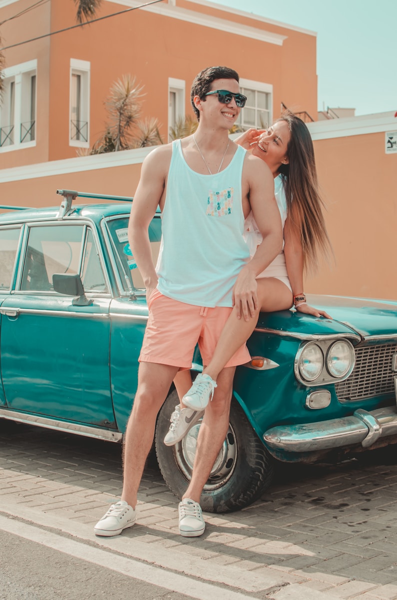 teen driver man and woman sitting on car